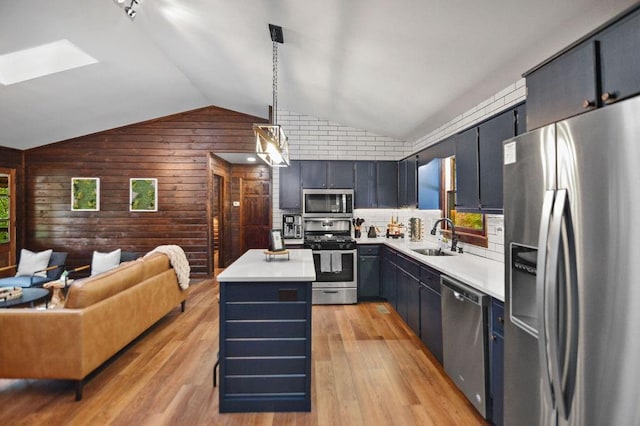307 Pigeon Creek Rd, Blue Ridge, GA 30513 - kitchen with appliances with stainless steel finishes, wooden walls, vaulted ceiling, a center island, and open floor plan