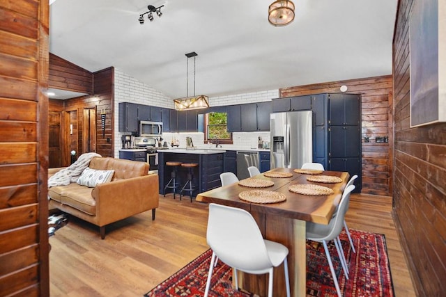 307 Pigeon Creek Rd, Blue Ridge, GA 30513 - dining space with lofted ceiling, wooden walls, and light wood-type flooring