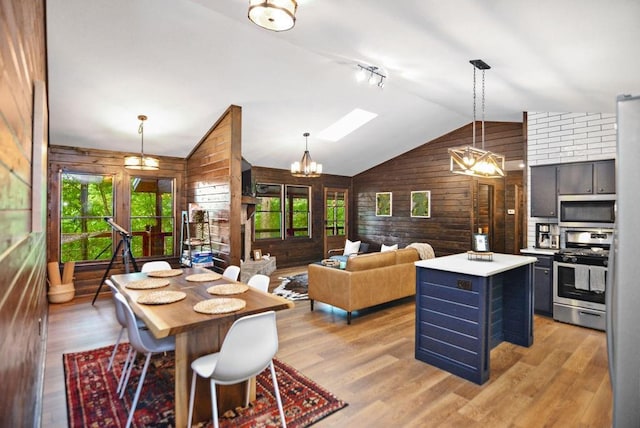 307 Pigeon Creek Rd, Blue Ridge, GA 30513 - dining space featuring wooden walls, healthy amount of natural light, vaulted ceiling, and light wood-type flooring