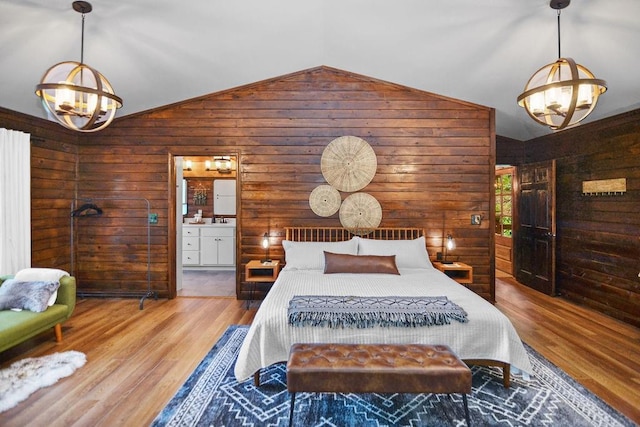 307 Pigeon Creek Rd, Blue Ridge, GA 30513 - bedroom featuring a chandelier, wooden walls, lofted ceiling, wood finished floors, and ensuite bath