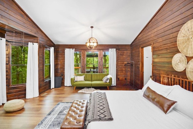 307 Pigeon Creek Rd, Blue Ridge, GA 30513 - bedroom with lofted ceiling, wooden walls, wood finished floors, and a chandelier