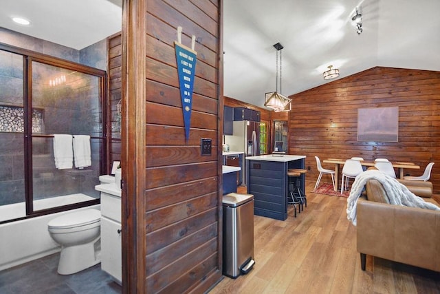 307 Pigeon Creek Rd, Blue Ridge, GA 30513 - living room with wooden walls, vaulted ceiling, and light wood-style flooring