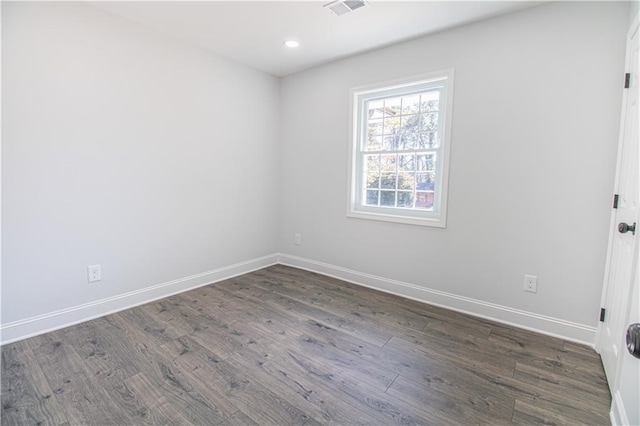 unfurnished room with dark wood-type flooring