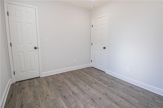 spare room with dark wood-type flooring