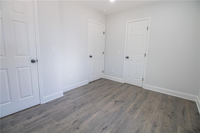 unfurnished bedroom featuring dark hardwood / wood-style floors