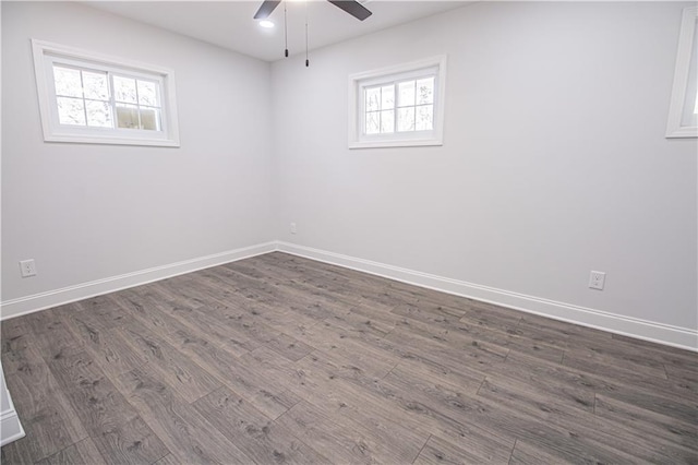 empty room with dark wood-type flooring and ceiling fan