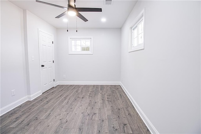 spare room featuring hardwood / wood-style flooring and ceiling fan