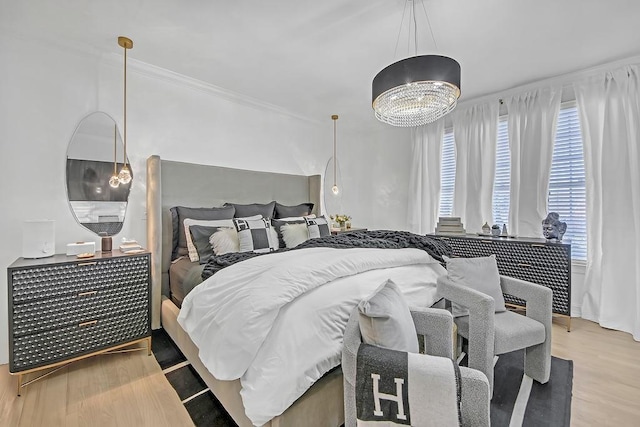 bedroom featuring a chandelier and light hardwood / wood-style floors