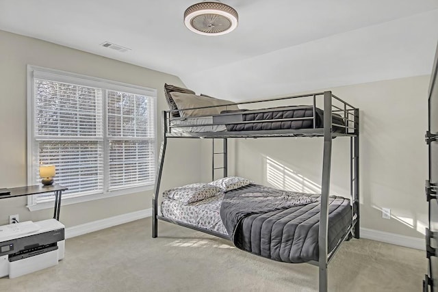 bedroom featuring light carpet and lofted ceiling