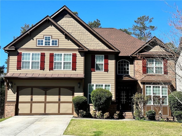 craftsman house with a garage and a front yard