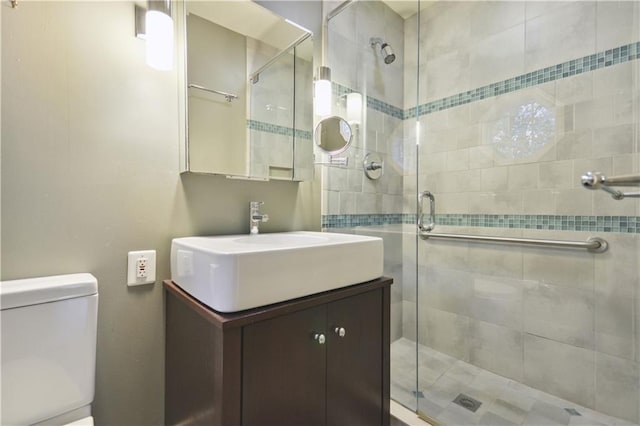 bathroom featuring a stall shower, vanity, and toilet