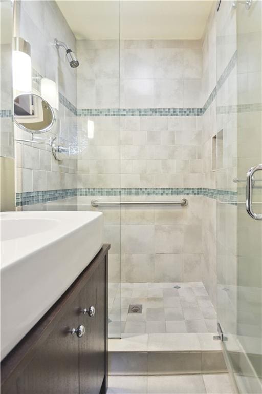 full bathroom featuring a shower stall and vanity