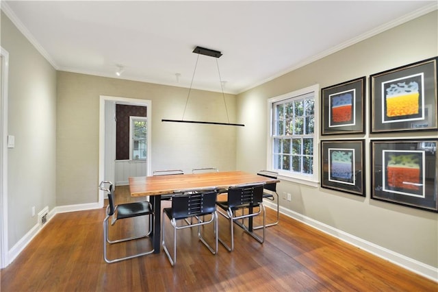 dining space with a wealth of natural light, dark wood finished floors, and baseboards