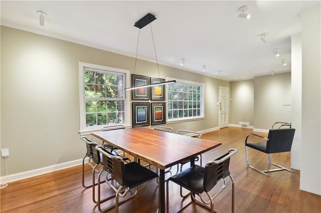 dining space with plenty of natural light, baseboards, and wood finished floors