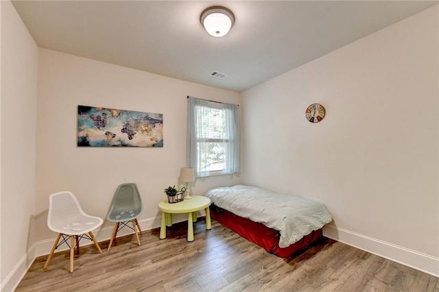 bedroom with hardwood / wood-style flooring