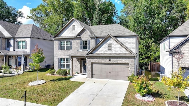 view of front of property with a front yard, cooling unit, and a garage