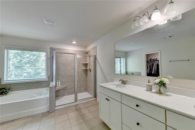 bathroom featuring independent shower and bath, vanity, and tile patterned floors