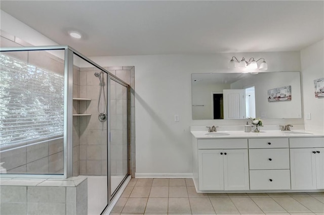 bathroom featuring tile patterned flooring, a shower with door, and vanity