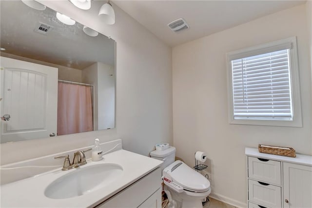 bathroom featuring vanity and toilet