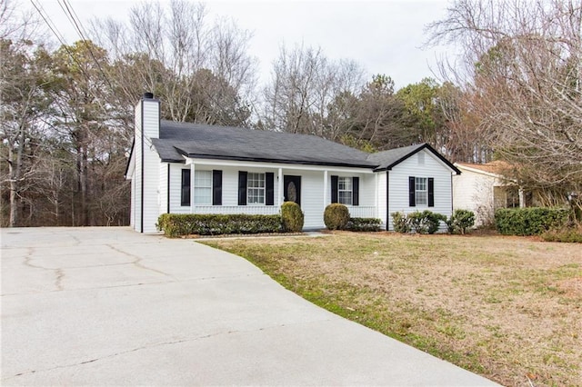 ranch-style house featuring a chimney and a front lawn