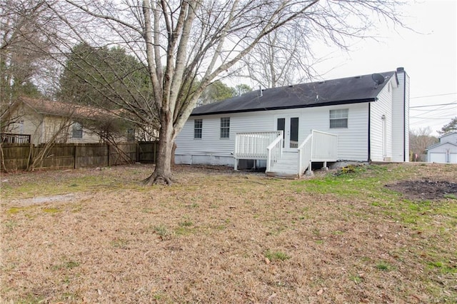 back of house featuring a yard, crawl space, fence, and a deck