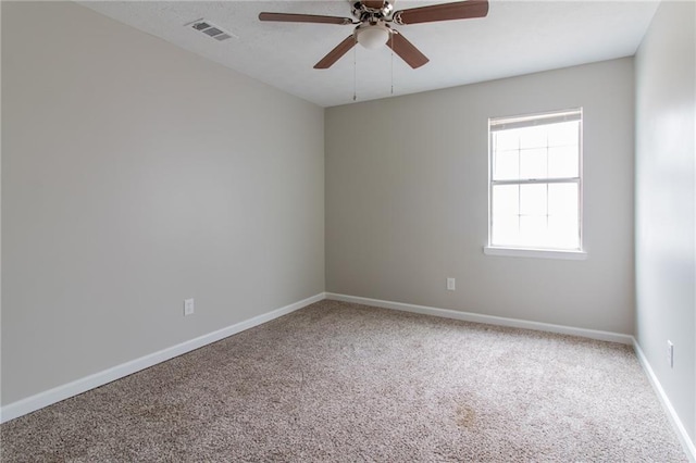 unfurnished room with a ceiling fan, carpet, visible vents, and baseboards