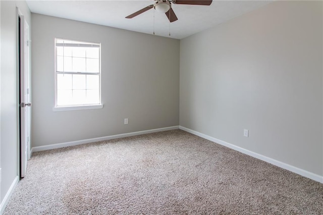 spare room featuring carpet, baseboards, and ceiling fan