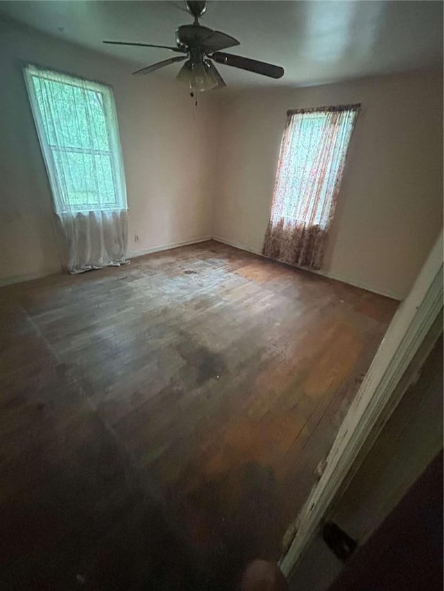 unfurnished room featuring hardwood / wood-style floors and ceiling fan