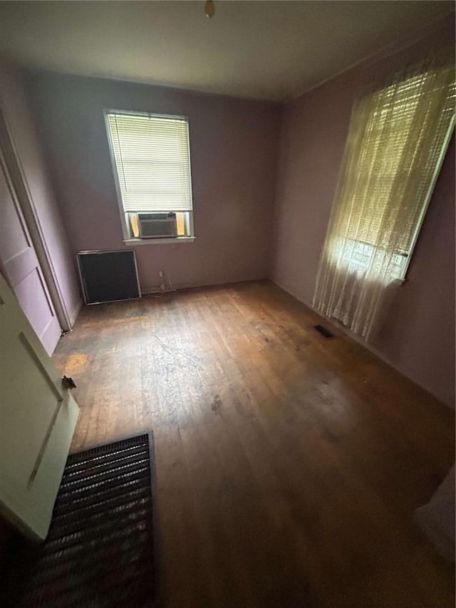 unfurnished room featuring hardwood / wood-style flooring and cooling unit