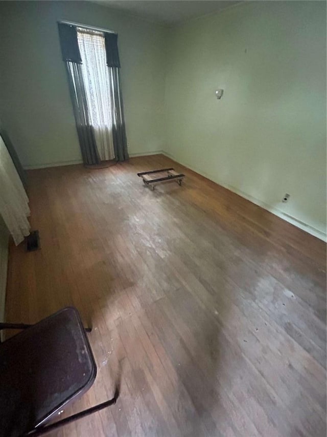 unfurnished room with hardwood / wood-style floors