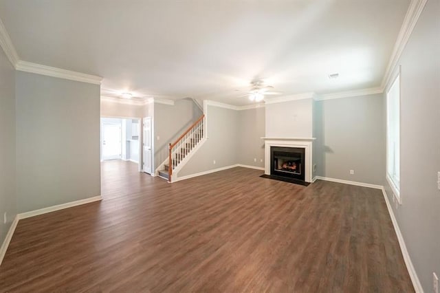 unfurnished living room with dark hardwood / wood-style flooring, ornamental molding, and ceiling fan