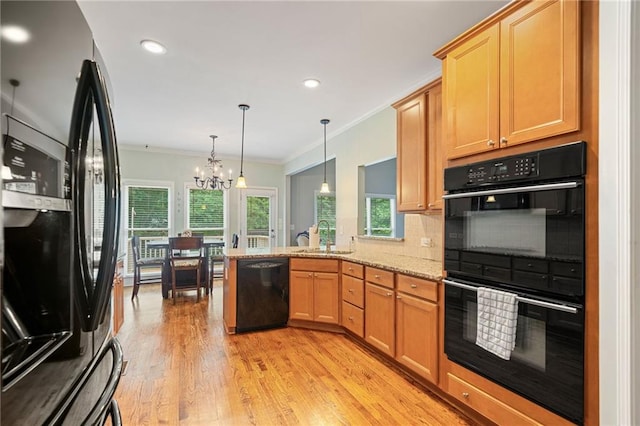 4915 Lazy Creek Ct, Cumming, GA 30028 - kitchen with black appliances, a sink, a peninsula, crown molding, and light wood-type flooring