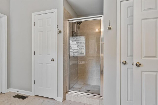 4915 Lazy Creek Ct, Cumming, GA 30028 - bathroom with a stall shower, tile patterned flooring, and baseboards