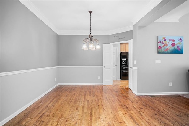 4915 Lazy Creek Ct, Cumming, GA 30028 - spare room featuring a chandelier, light wood-style floors, ornamental molding, and baseboards