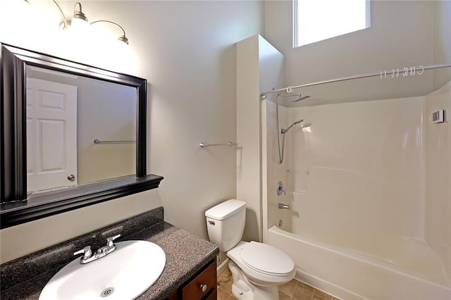 bathroom featuring toilet, tub / shower combination, vanity, and tile patterned floors