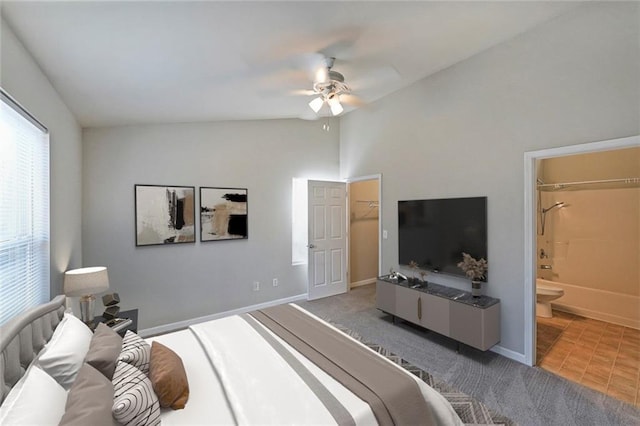 carpeted bedroom featuring lofted ceiling, ceiling fan, baseboards, and ensuite bathroom