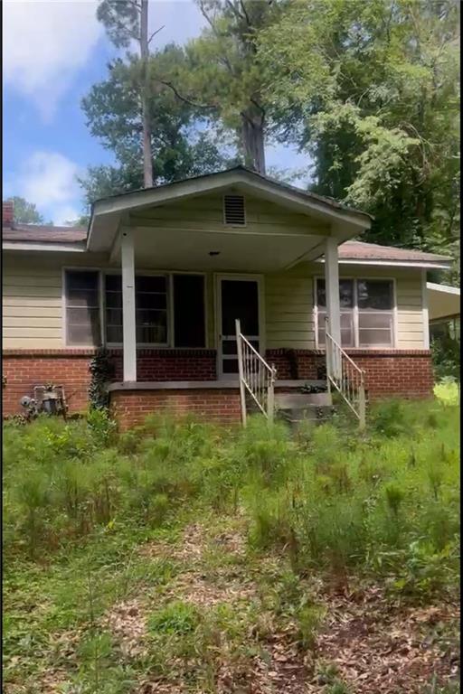 5103 NW Berry St NW, Covington, GA 30014 - view of front of property with brick siding and a porch
