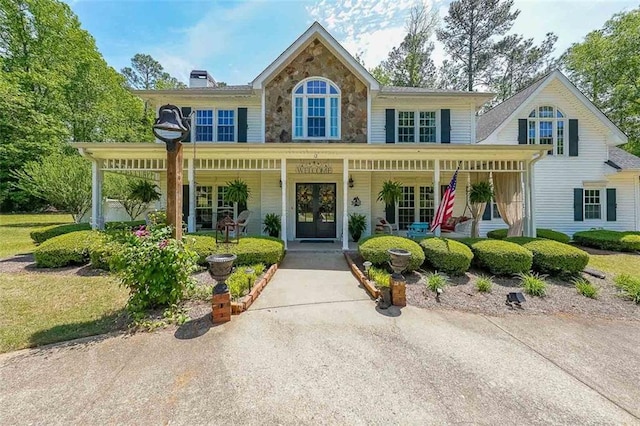 12 Blackfoot Trl, Sharpsburg, GA 30277 - view of front of home featuring a porch, french doors, stone siding, and a chimney