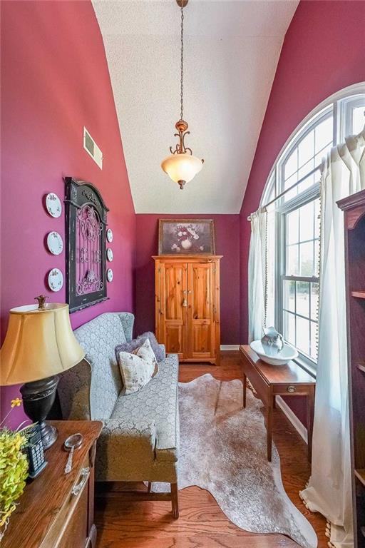 12 Blackfoot Trl, Sharpsburg, GA 30277 - living area with high vaulted ceiling and wood finished floors