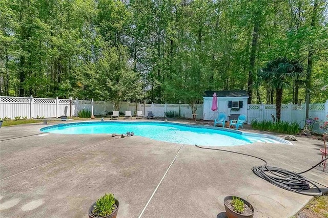 12 Blackfoot Trl, Sharpsburg, GA 30277 - view of swimming pool with a patio area, a fenced backyard, an outdoor structure, and a shed