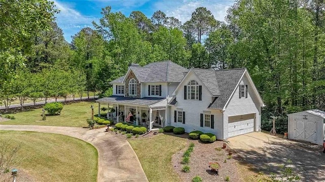 12 Blackfoot Trl, Sharpsburg, GA 30277 - view of front of house featuring a porch, an attached garage, driveway, a storage shed, and a front yard