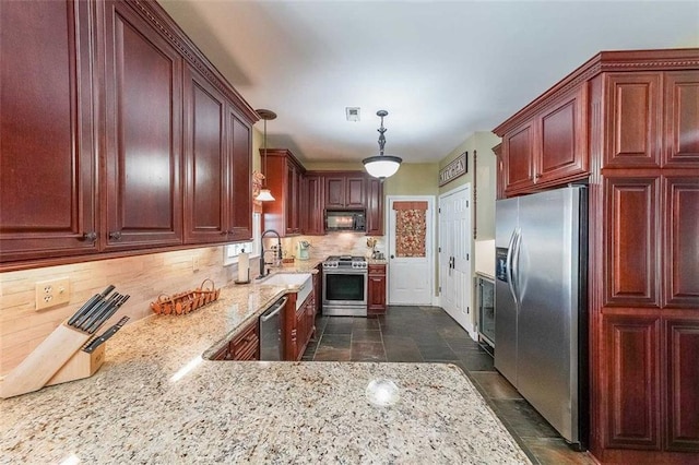 12 Blackfoot Trl, Sharpsburg, GA 30277 - kitchen with appliances with stainless steel finishes, a sink, decorative backsplash, light stone countertops, and decorative light fixtures