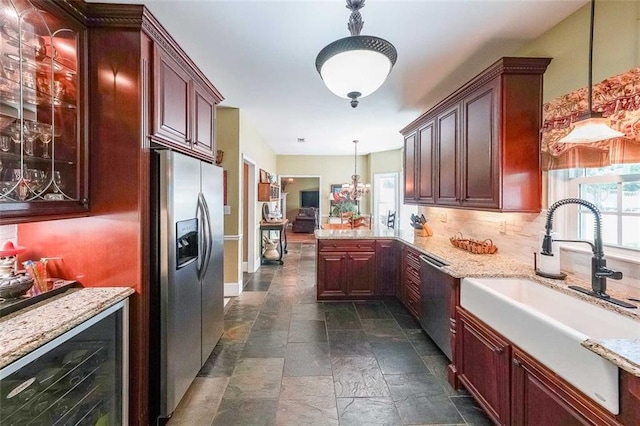 12 Blackfoot Trl, Sharpsburg, GA 30277 - kitchen with appliances with stainless steel finishes, a sink, light stone countertops, a peninsula, and wine cooler