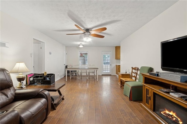 136 Pine St, Covington, GA 30014 - living area with a ceiling fan, wood-type flooring, and a textured ceiling