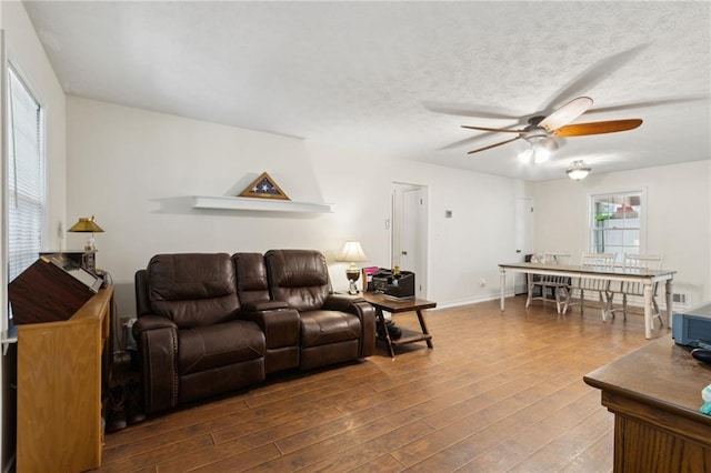 136 Pine St, Covington, GA 30014 - living area with a ceiling fan and wood finished floors