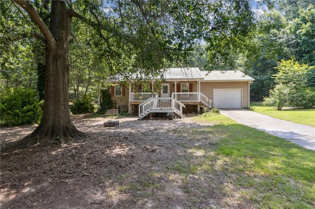 136 Pine St, Covington, GA 30014 - ranch-style house with covered porch, a garage, stairway, driveway, and a metal roof