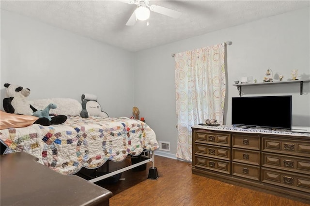 136 Pine St, Covington, GA 30014 - bedroom featuring wood finished floors, a ceiling fan, and a textured ceiling