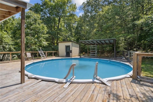 136 Pine St, Covington, GA 30014 - swimming pool featuring a wooden deck, view of scattered trees, and a storage unit