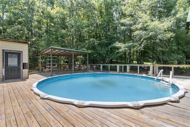 136 Pine St, Covington, GA 30014 - outdoor pool featuring a wooden deck and view of wooded area