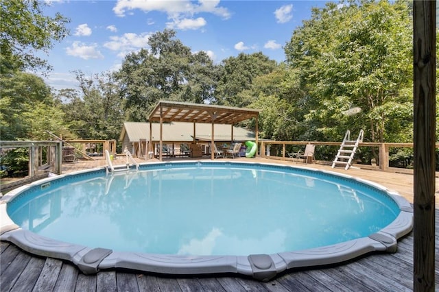 136 Pine St, Covington, GA 30014 - swimming pool with a deck and view of scattered trees
